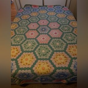 Vintage grandmother’s flower garden quilt